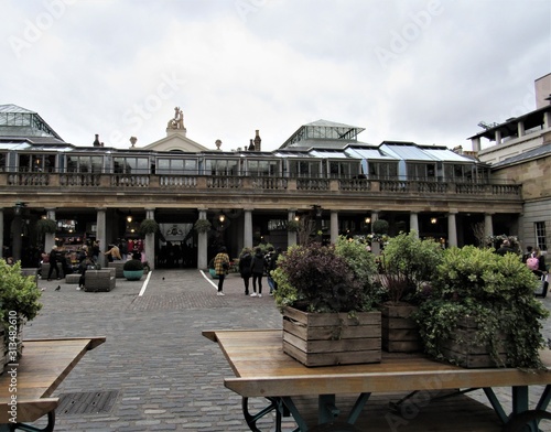 Unrecognizable tourists and locals shopping and visiting at Apple Market in Covent Garden 
