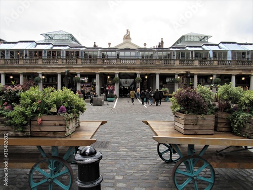 Unrecognizable tourists and locals shopping and visiting at Apple Market in Covent Garden  photo