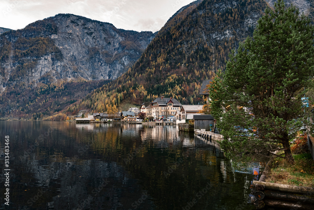 Hallstatter lake and Hallstatt village in Austrian Alps / Evening light during autumn season / One of most popular tourist location in Austria