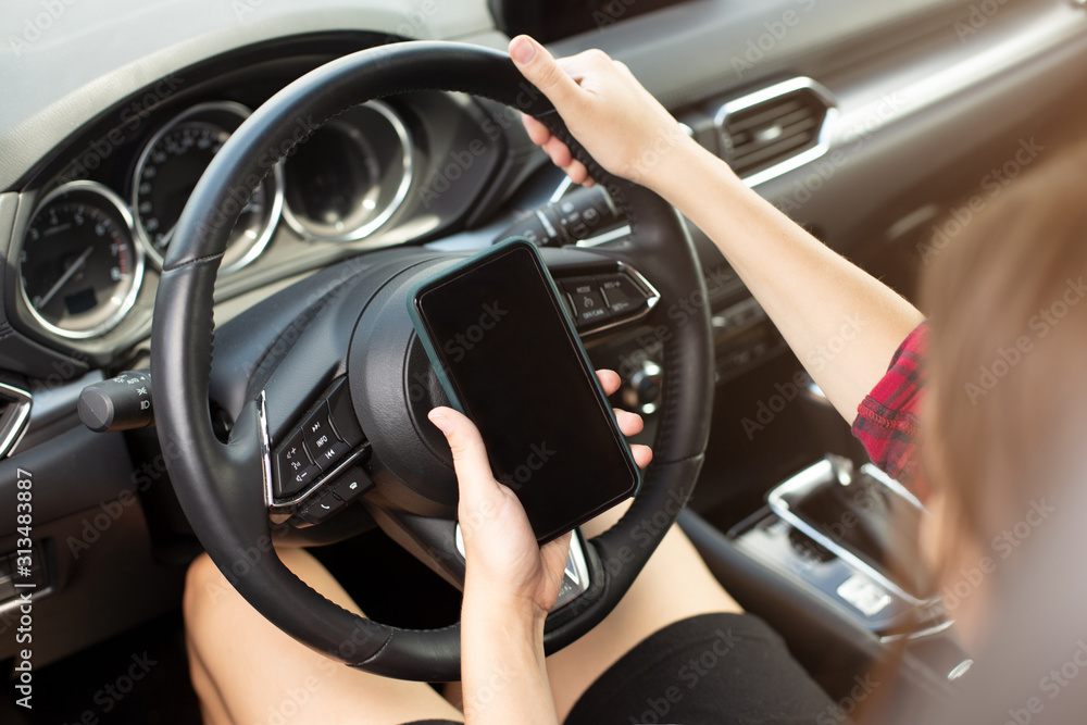 Woman with smartphone in car Woman with smartphone in car