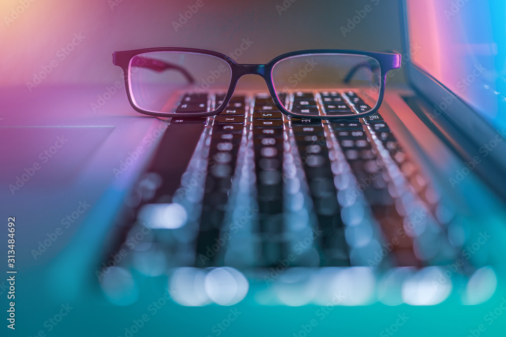 Simple glasses on laptop computer keyboard Simple glasses on laptop computer keyboard
