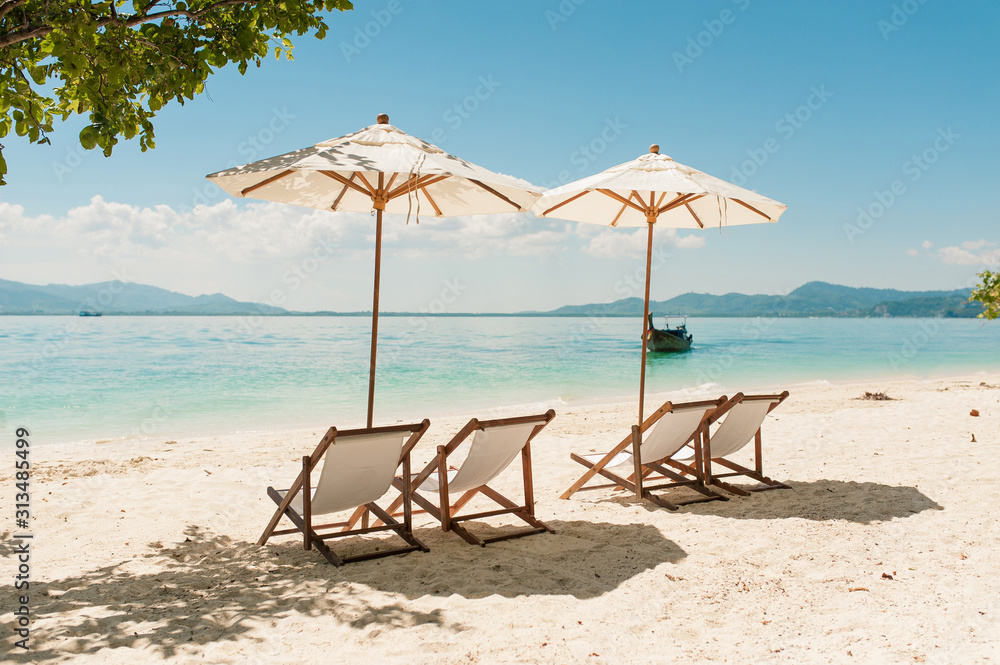 Wooden empty chairs and umbrella on luxury resort beach hotel. Relax on the beach, sea and blue sky. Sea view from beach background for holiday vacation concept