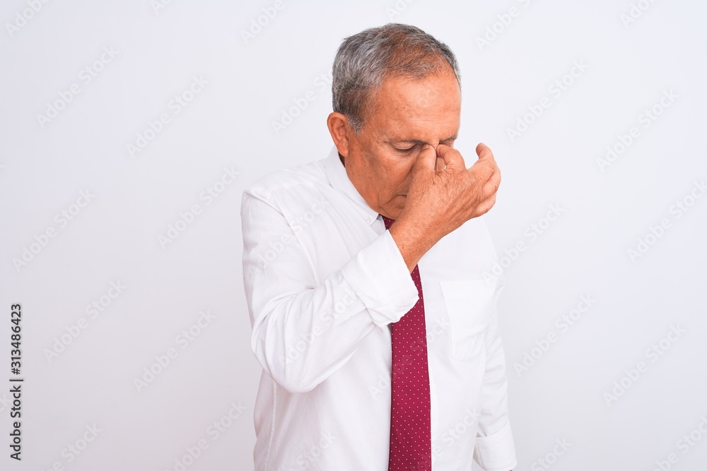Senior grey-haired businessman wearing elegant tie over isolated white background tired rubbing nose and eyes feeling fatigue and headache. Stress and frustration concept. Senior grey-haired businessman wearing elegant tie over isolated white background tired rubbing nose and eyes feeling fatigue and headache. Stress and frustration concept.