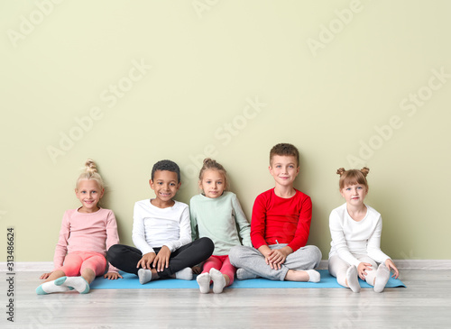 Little children with yoga m...