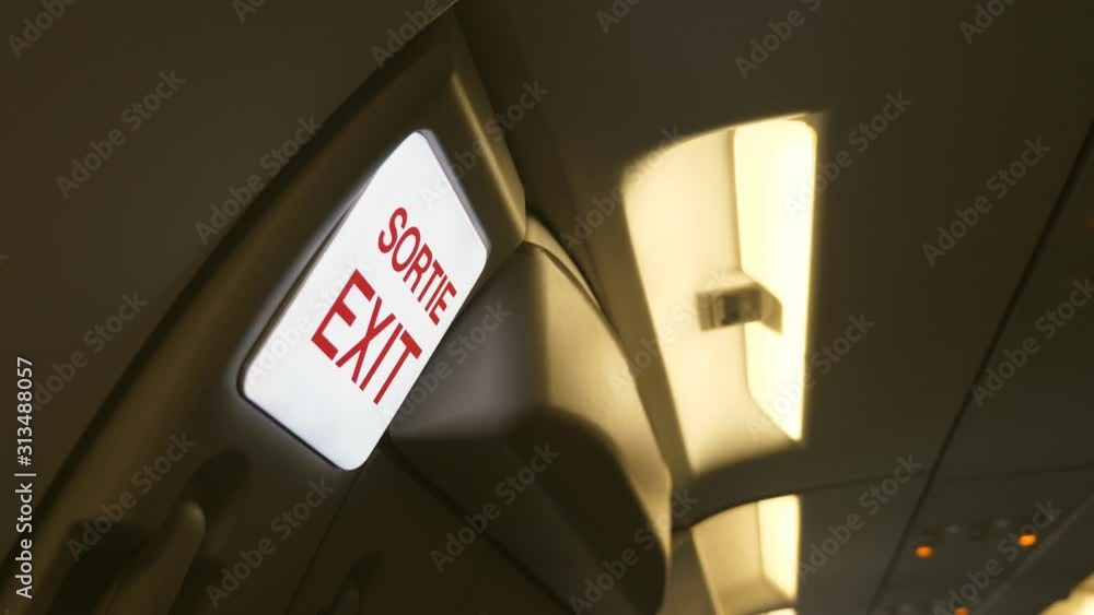 Exit Sortie sign. Interior of jet plane. French and English language. Exit Sortie sign. Interior of jet plane. French and English language.