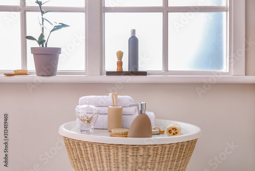 Body care cosmetics with accessories on table in bathroom