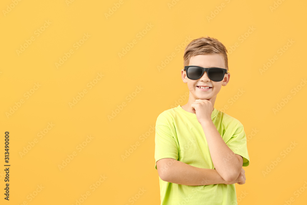 Cute little boy with sunglasses on color background Cute little boy with sunglasses on color background