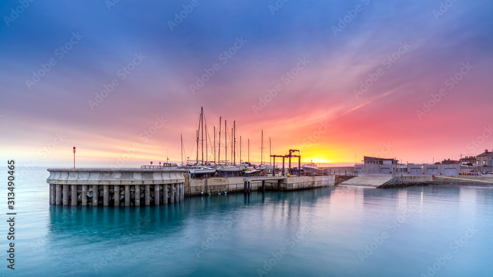 Amazing sky on sunrise at Greystones yacht marina or harbour with boats in dry dock. County Wicklow, Ireland