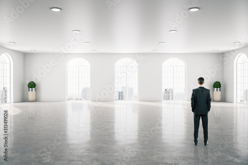 Businessman standing in modern gallery interior