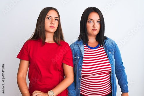 Young beautiful women wearing casual clothes standing over isolated white background looking sleepy and tired, exhausted for fatigue and hangover, lazy eyes in the morning.