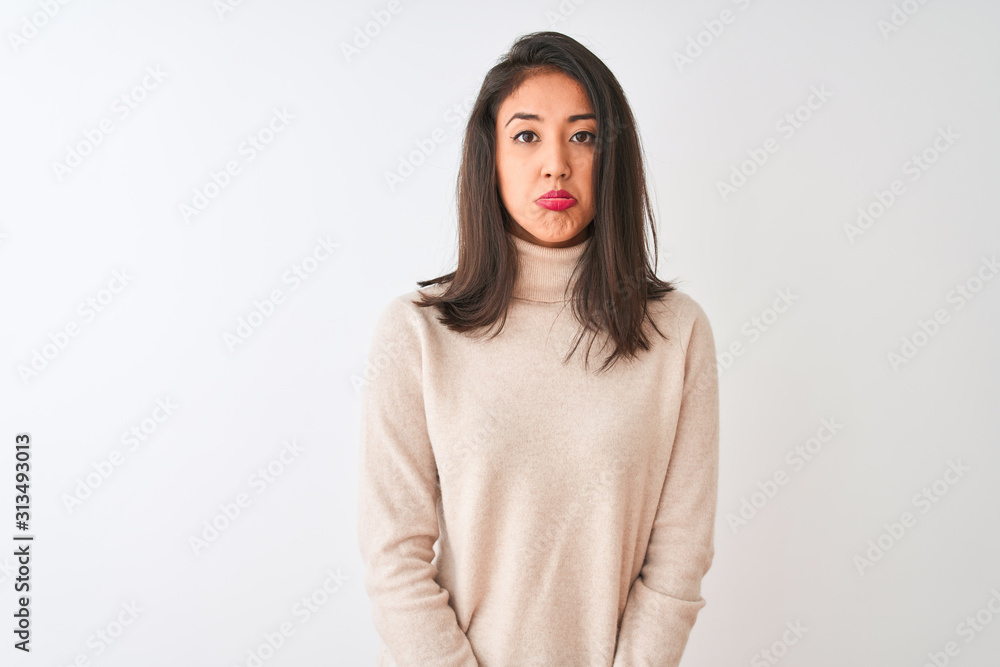 Beautiful chinese woman wearing turtleneck sweater standing over isolated white background depressed and worry for distress, crying angry and afraid. Sad expression. Beautiful chinese woman wearing turtleneck sweater standing over isolated white background depressed and worry for distress, crying angry and afraid. Sad expression.