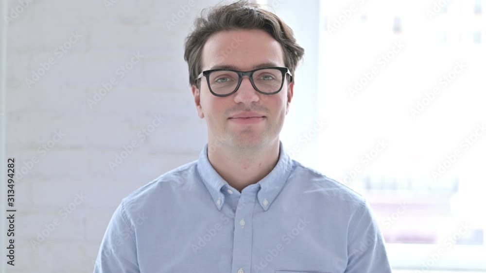 Portrait of Young Man saying Yes by Shaking Head Portrait of Young Man saying Yes by Shaking Head