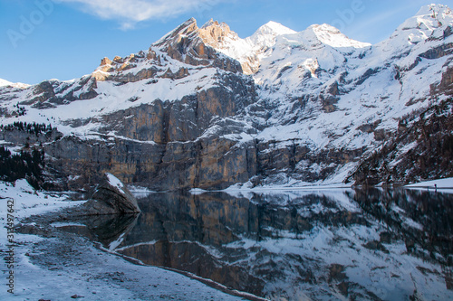 Oeschinen lake and swiss alps, covered by snow
