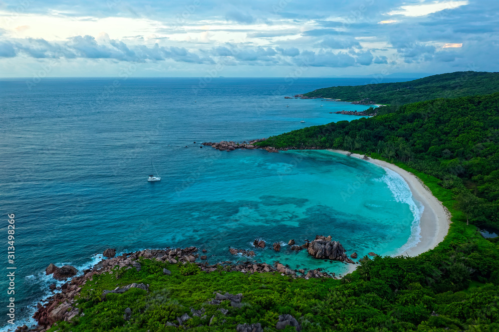 Naklejka premium Landscape Seychelles Island La Digue in Indian ocean, beautiful blue sea with waves, sand beaches and green forest in the tropical paradise. Travel pictures