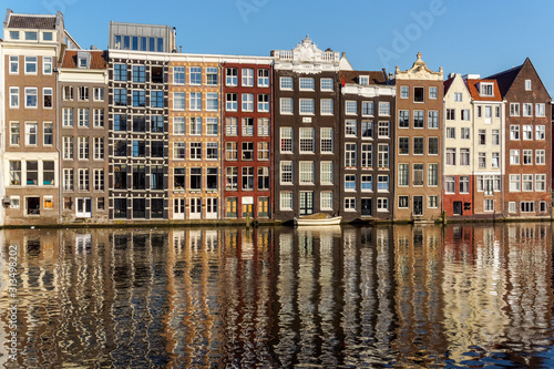 Traditional Dutch buildings at Damrak in Amsterdam, Netherlands © Marcin Rogozinski