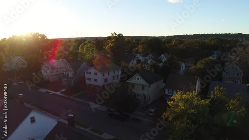 A drone taking off in a suburban backyard providing a skyline view of a suburban town, aerial shot in 4k photo