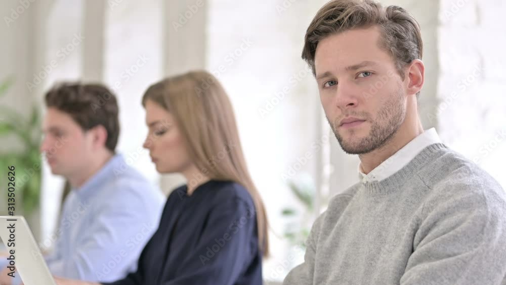Portrait of Serious Creative Man Looking at the Camera in Office Portrait of Serious Creative Man Looking at the Camera in Office