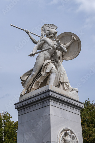 Sculpture from white Carrara marble at Palace Bridge (Schlossbrucke, built in 1824) is between Palace Square (Schlossplatz) and famous avenue Unter den Linden. Berlin, Germany. photo