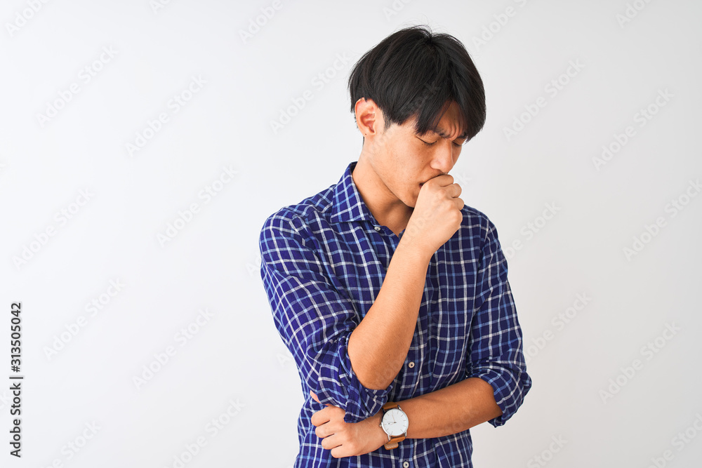 Young chinese man wearing casual blue shirt standing over isolated white background feeling unwell and coughing as symptom for cold or bronchitis. Healthcare concept. Young chinese man wearing casual blue shirt standing over isolated white background feeling unwell and coughing as symptom for cold or bronchitis. Healthcare concept.