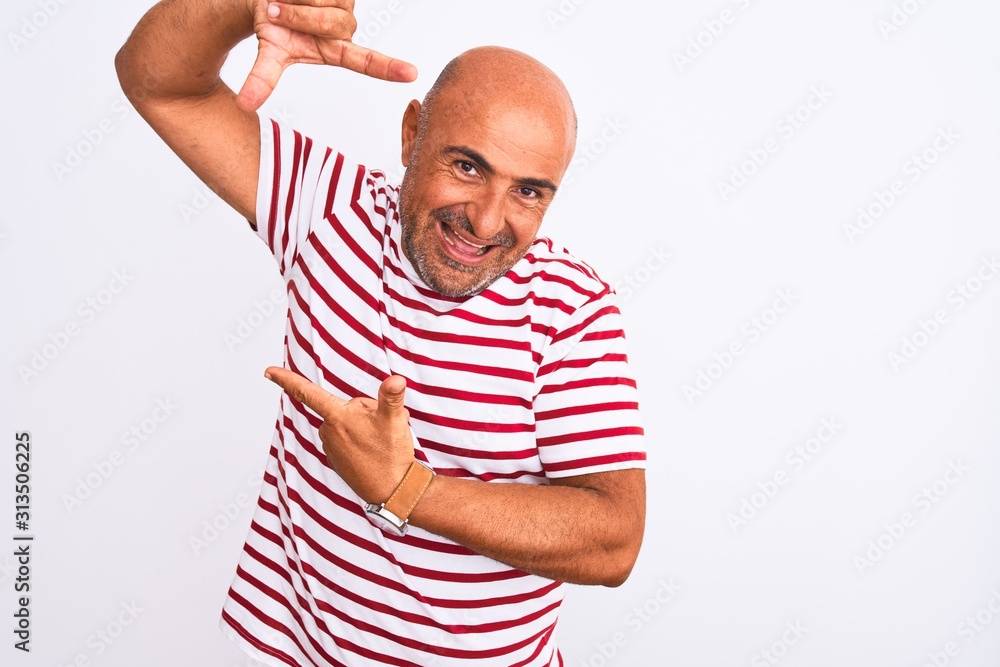 Middle age handsome man wearing striped t-shirt standing over isolated white background smiling making frame with hands and fingers with happy face. Creativity and photography concept. Middle age handsome man wearing striped t-shirt standing over isolated white background smiling making frame with hands and fingers with happy face. Creativity and photography concept.