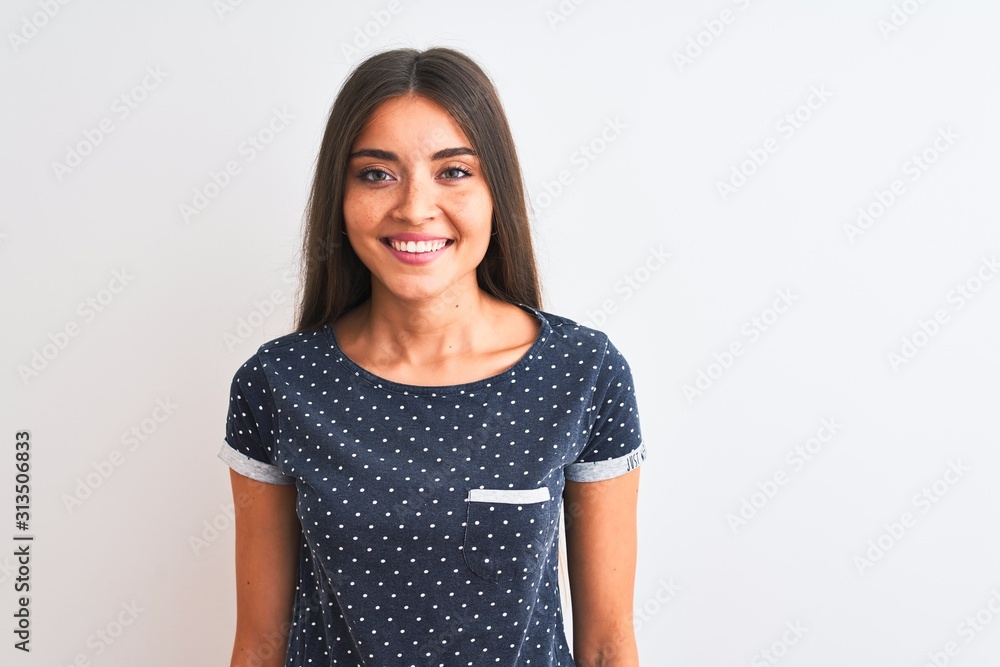 Young beautiful woman wearing blue casual t-shirt standing over isolated white background with a happy and cool smile on face. Lucky person. Young beautiful woman wearing blue casual t-shirt standing over isolated white background with a happy and cool smile on face. Lucky person.