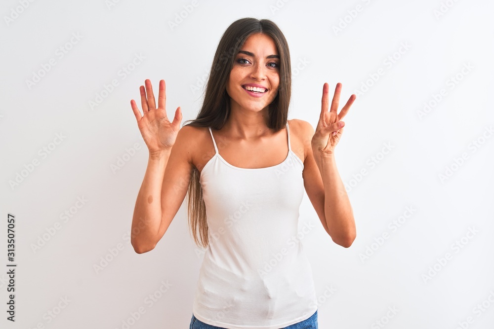 Young beautiful woman wearing casual t-shirt standing over isolated white background showing and pointing up with fingers number eight while smiling confident and happy. Young beautiful woman wearing casual t-shirt standing over isolated white background showing and pointing up with fingers number eight while smiling confident and happy.
