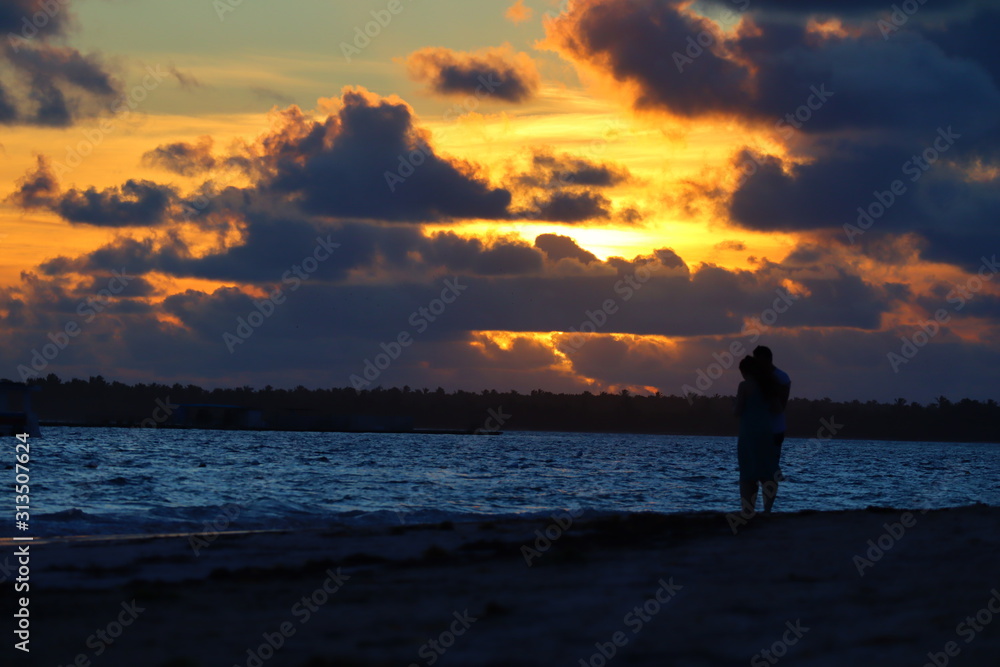 Couple standing in the sunrise