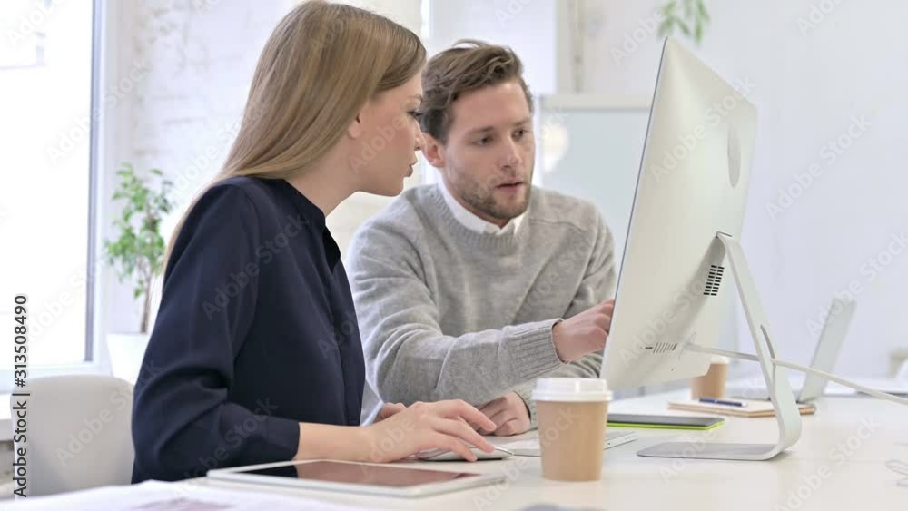 Professional Creative Team Discussing and Working on Desktop