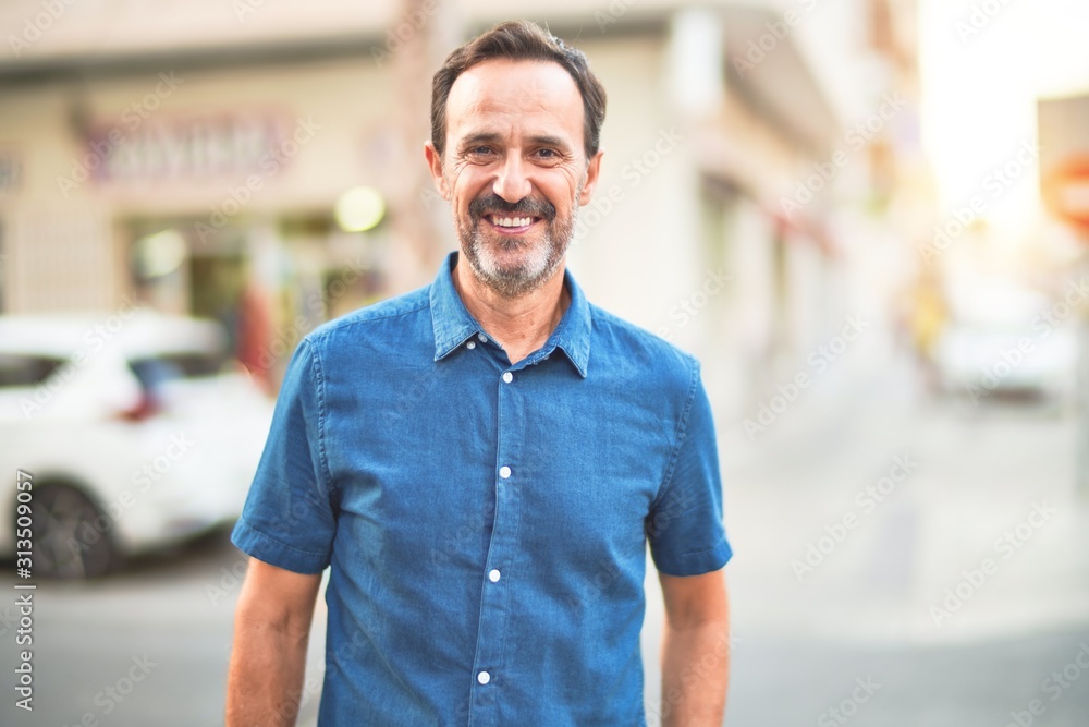 Middle age handsome man standing on the street smiling - obrazy, fototapety, plakaty 