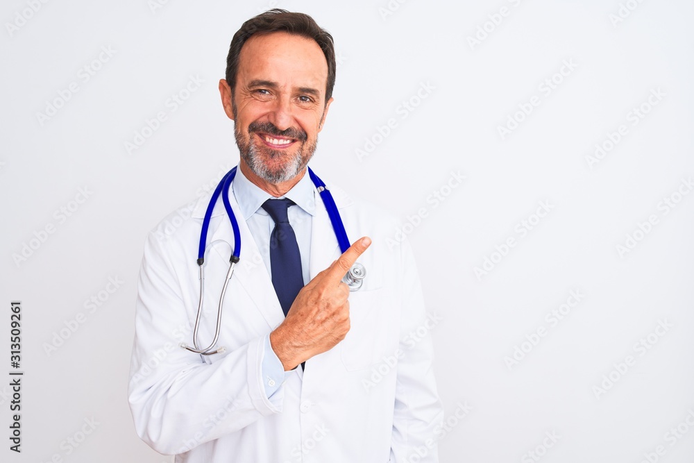 Middle age doctor man wearing coat and stethoscope standing over isolated white background cheerful with a smile of face pointing with hand and finger up to the side with happy and natural expression Middle age doctor man wearing coat and stethoscope standing over isolated white background cheerful with a smile of face pointing with hand and finger up to the side with happy and natural expression