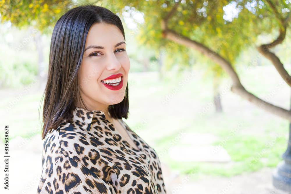 Naklejka premium Young beautiful woman with red lips smiling happy at garden