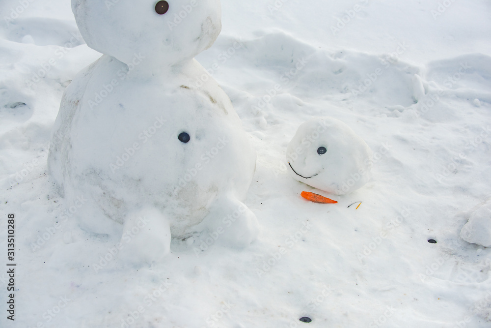 Melted snowman in puddle. Is my first snowman. Lonely snowman melting after Christmas. Melted snowman in puddle. Is my first snowman. Lonely snowman melting after Christmas.