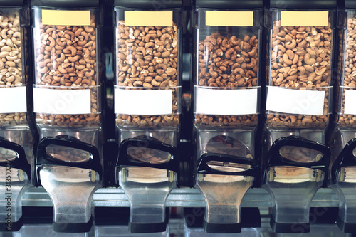 Dispensers with nuts in zero waste shop. New trend alternative buying.