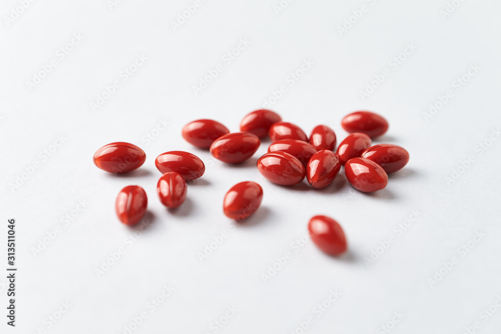 Beta-Carotene tablets. Antioxidants. Concept for a healthy dietary supplementation. Bright paper background. Close up. Beta-Carotene tablets. Antioxidants. Concept for a healthy dietary supplementation. Bright paper background. Close up.