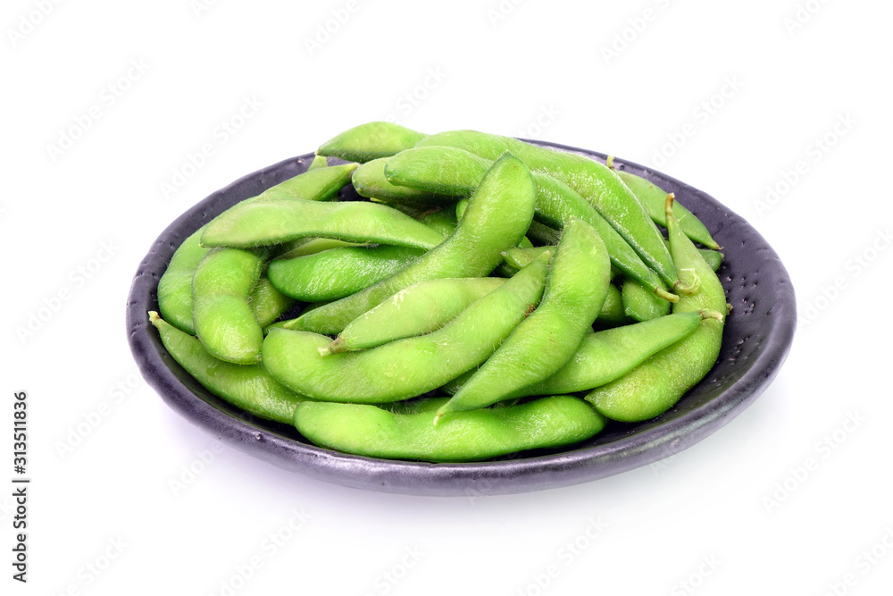 Edamame beans on Japanese black earthenware dish Isolated on white background. Steamed salted soybeans, the popular appetizer of Japanese cuisine. Edamame beans on Japanese black earthenware dish Isolated on white background. Steamed salted soybeans, the popular appetizer of Japanese cuisine.