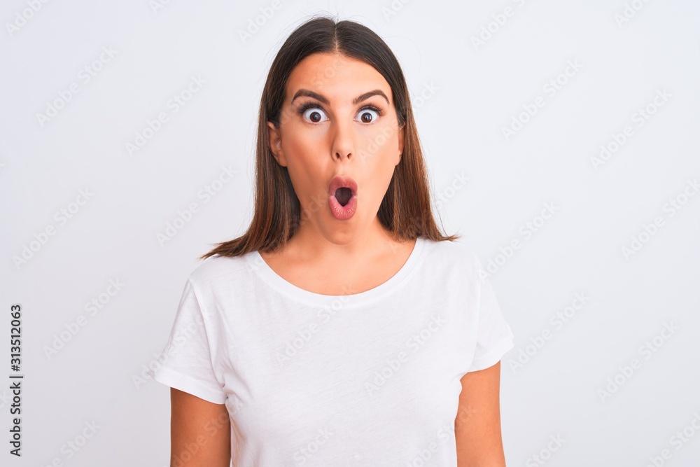 Portrait of beautiful and young brunette woman standing over isolated white background afraid and shocked with surprise expression, fear and excited face. Portrait of beautiful and young brunette woman standing over isolated white background afraid and shocked with surprise expression, fear and excited face.