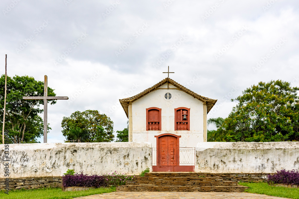 Small and old church and crucifix in colonial architecture in the interior of the state of Minhas Gerais, Brazil
