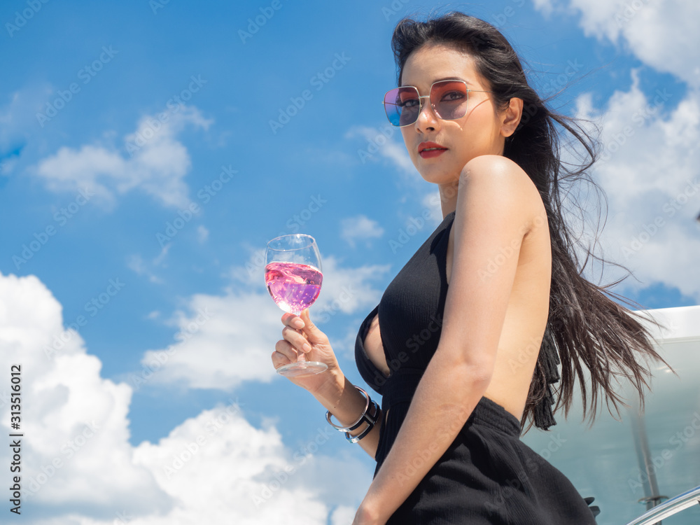 asia beautyful woman wearing black dress on luxury yacht ship in Pattaya sea Thailand with ocean blue sky island background copy space asia beautyful woman wearing black dress on luxury yacht ship in Pattaya sea Thailand with ocean blue sky island background copy space