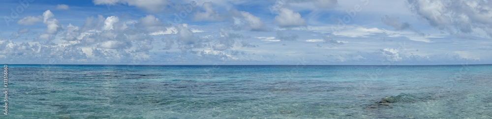 Panorama of blue sky and turquoise water in the Pacific Ocean off Bora Bora in French Polynesia