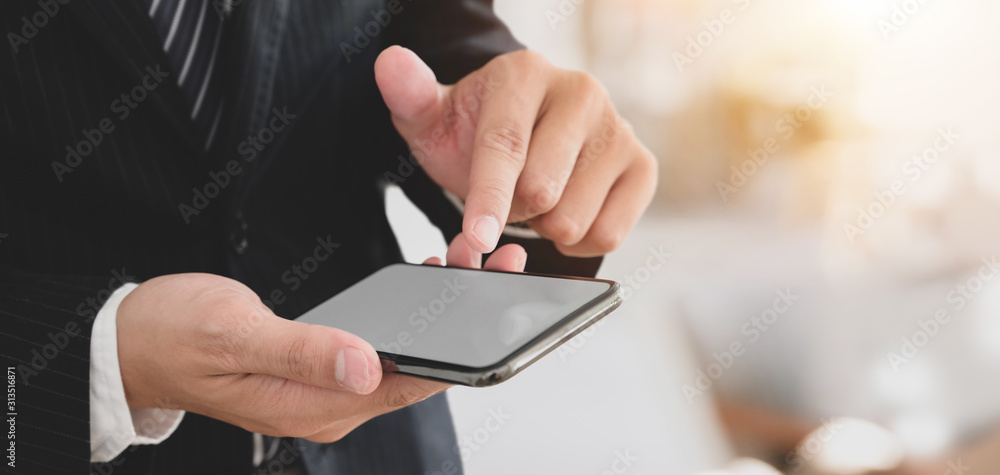 Close-up view of young professional businessman using smartphone Close-up view of young professional businessman using smartphone