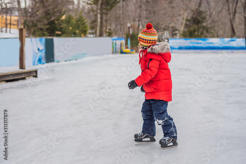 Boy ice skating for the first time