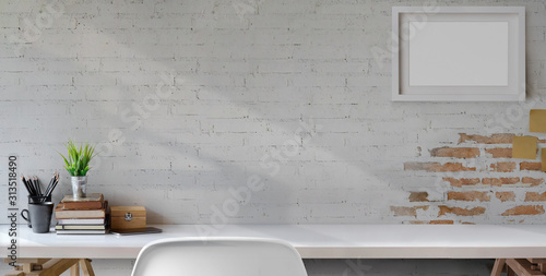 Top view of comfortable vintage workplace with office supplies and copy space on white table and brick wall