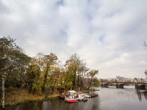 Panorama of the Old Town of Prague, Czech Republic, with focus Prague Castle (Prazsky hrad) seen from the Vltava river in autumn. The castle is the main touristic landmark of the city