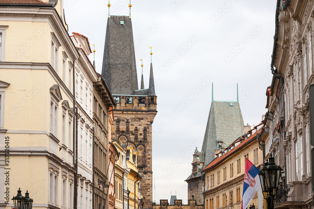 Picture of the lesser town bridge tower of Charles Bridge, also called malostranska mostecka vez in Prague, Czech Republic, surrounded by narrow medieval streets and houses