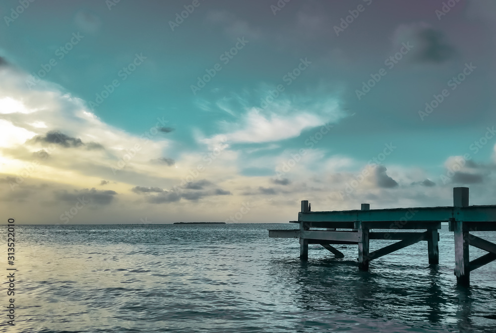 Dock on a hidden beach at sunset