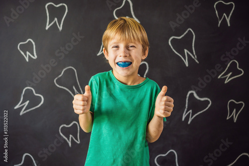 Six-year old boy shows myofunctional trainer. Helps equalize the growing teeth and correct bite, develop mouth breathing habit. Corrects the position of the tongue