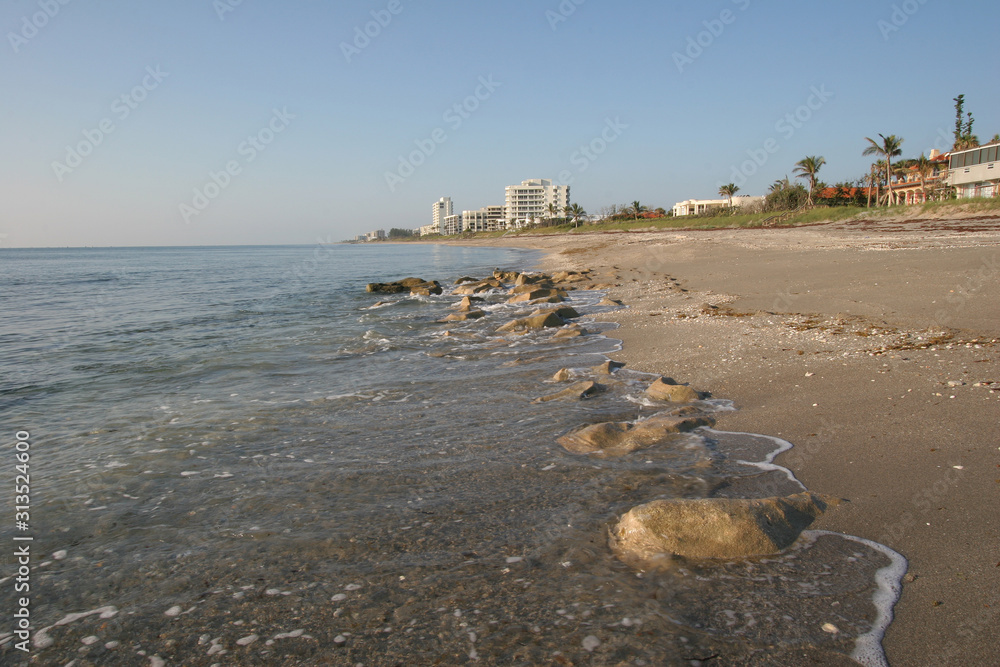 Beach at Coral Cove Park in Tequesta, Florida on clear cloudless morning at low tide.