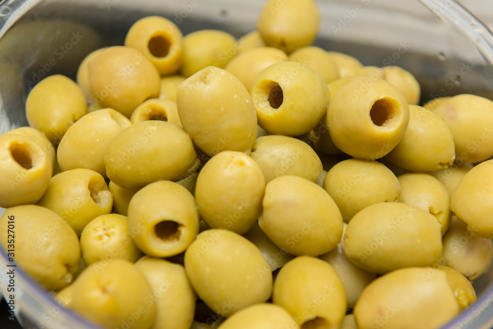 Closeup of pitted olives to be served and eaten by guests. A great taste that is usually accompanied by a beer. Selective focus. Closeup of pitted olives to be served and eaten by guests. A great taste that is usually accompanied by a beer. Selective focus.