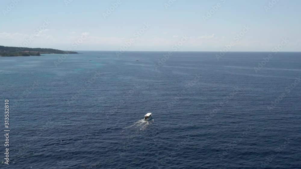 Aerial, wide rotate around scuba dive boat, reveal island of Roatan Aerial, wide rotate around scuba dive boat, reveal island of Roatan