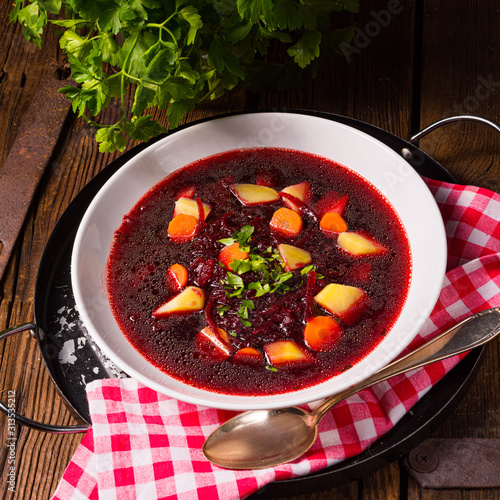 Delicious beetroot borscht with egg photo